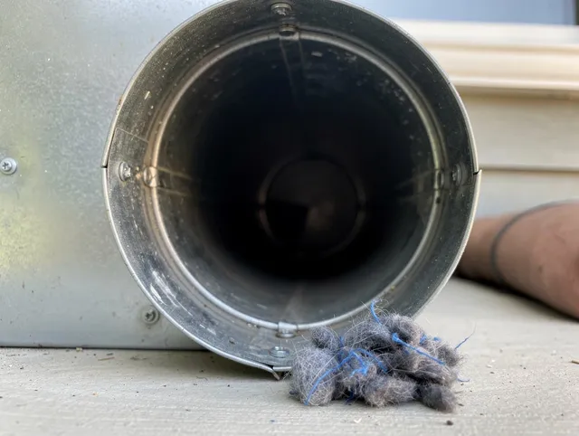 Newtown Dryer Vent Cleaning technician using specialized equipment to clear severe dryer vent blockage in Newtown